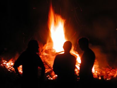 Silhouettes in front of bonfire
