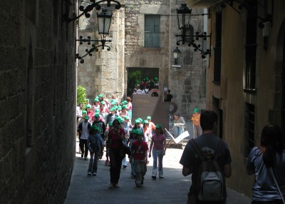 Crowd of children in green baseball caps