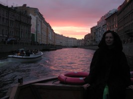 Anya in a boat at sunset